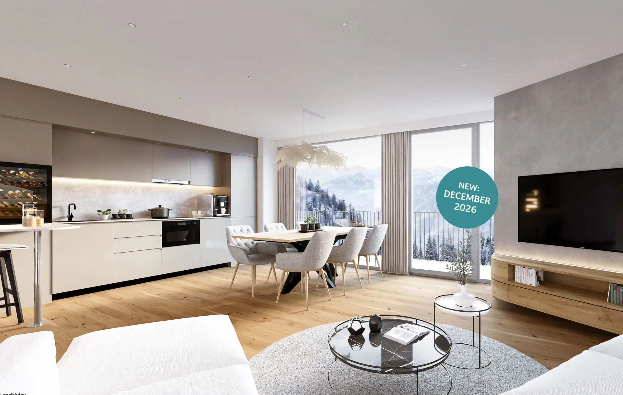 Modernes, offenes Wohnzimmer und Küche mit großen Fenstern, einem Esstisch und Blick auf die Berge. Türkiser Kreis mit weißer Schrift "New: December 2026" rechts im Bild. 